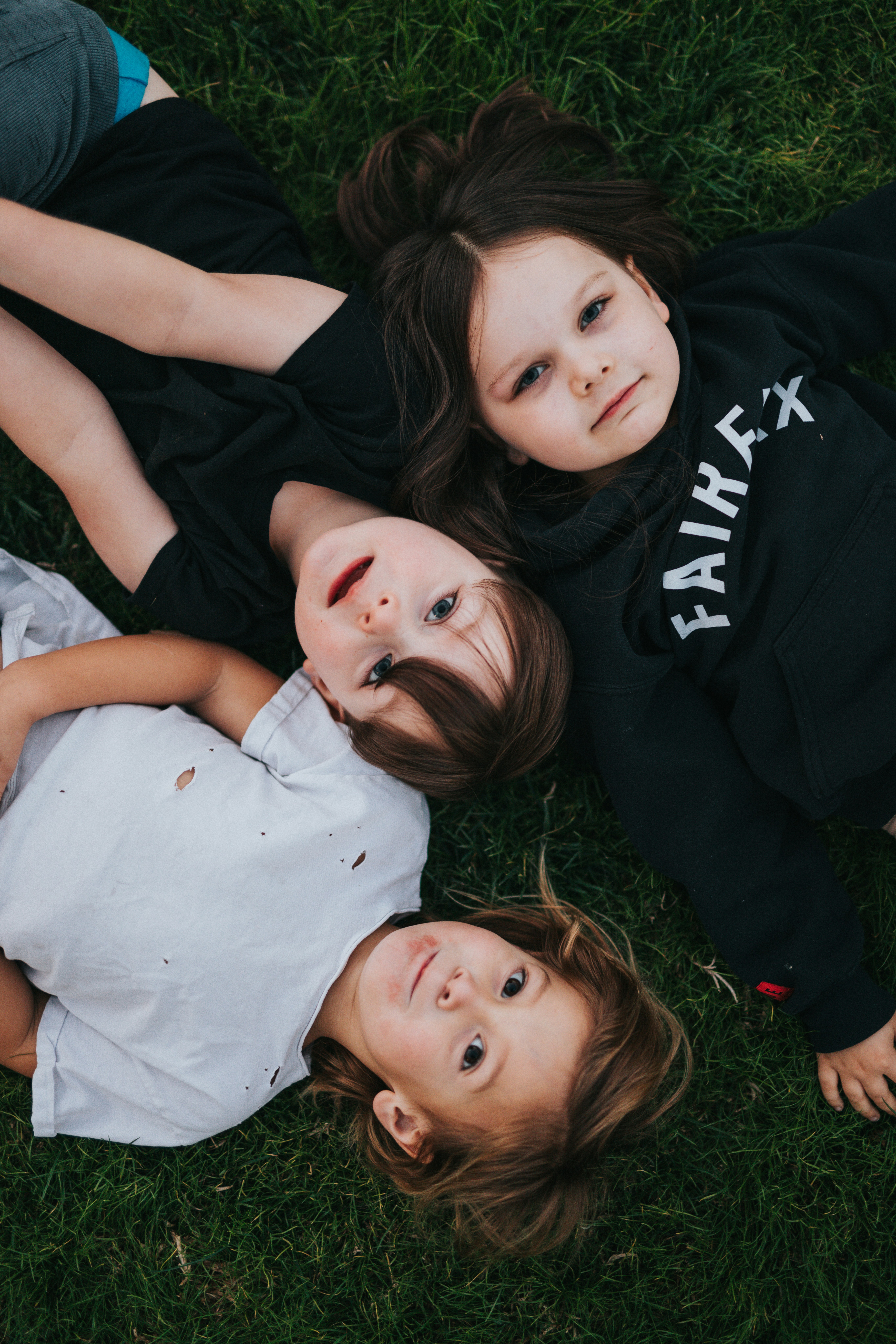 children laying on grass
